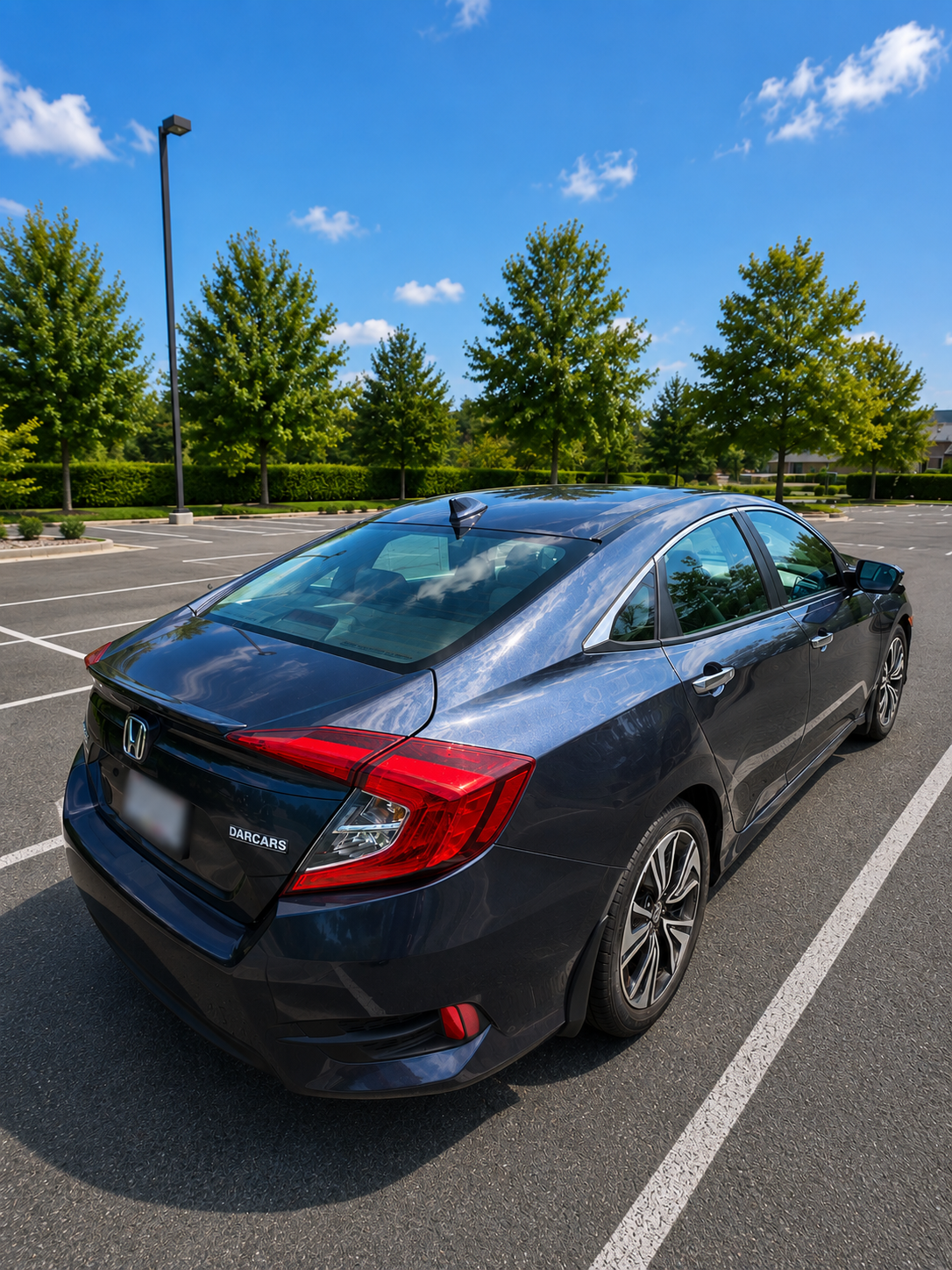 Rear three-quarter view of the dark blue 2016 Honda Civic Sedan